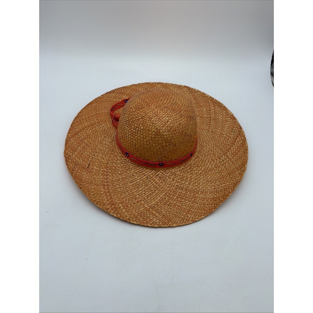 wide-brim woven straw sun hat featuring a reddish-orange band